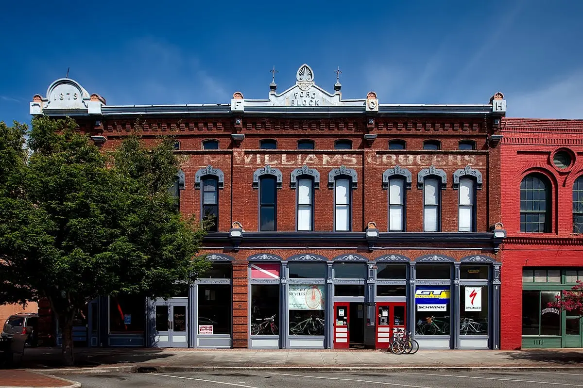 A historic building facade in oneonta, featuring stores and vintage architectural details.