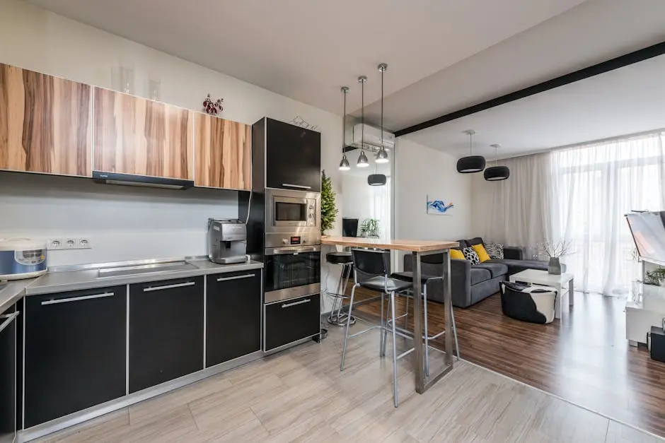Spacious modern interior with open-plan kitchen and cozy living area, featuring stylish furnishings.