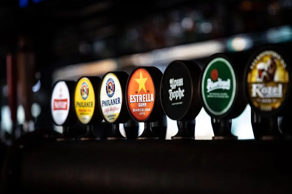 A close-up of various beer taps in a dimly lit bar, showcasing popular brands.