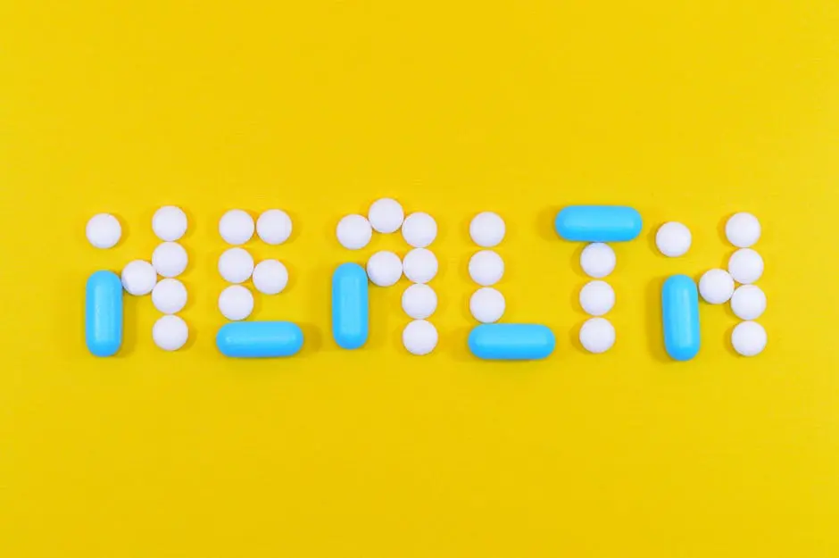 Pills spelling &lsquo;health&rsquo; on a vibrant yellow background, symbolizing wellness.