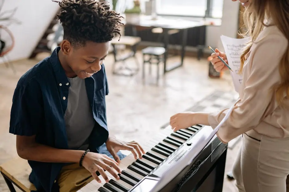 A young boy enjoying a piano lesson with a smiling teacher in a cozy indoor setting.