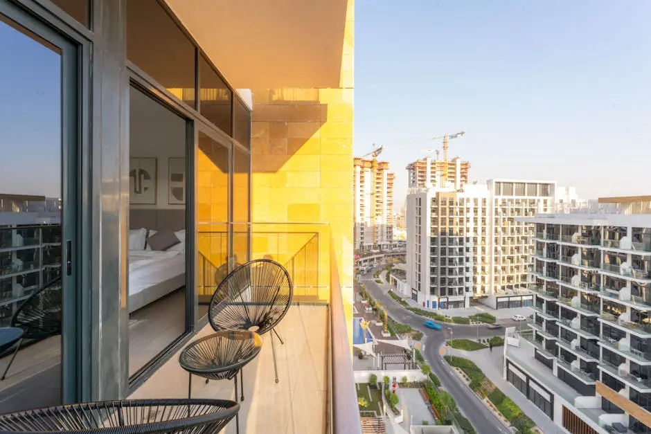 Spacious balcony view of modern Dubai apartments under construction at sunset.