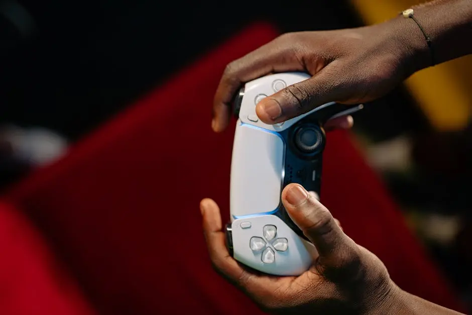 Hands gripping a wireless game controller, showcasing modern technology and gaming.
