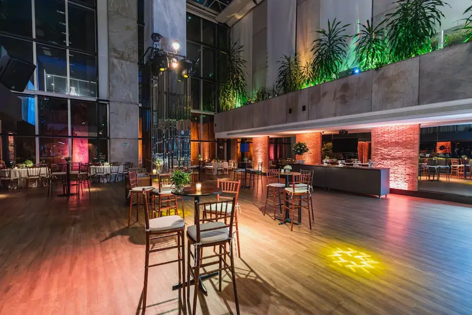 A spacious modern banquet hall with elegant ambient lighting and stylish decor, perfect for events.