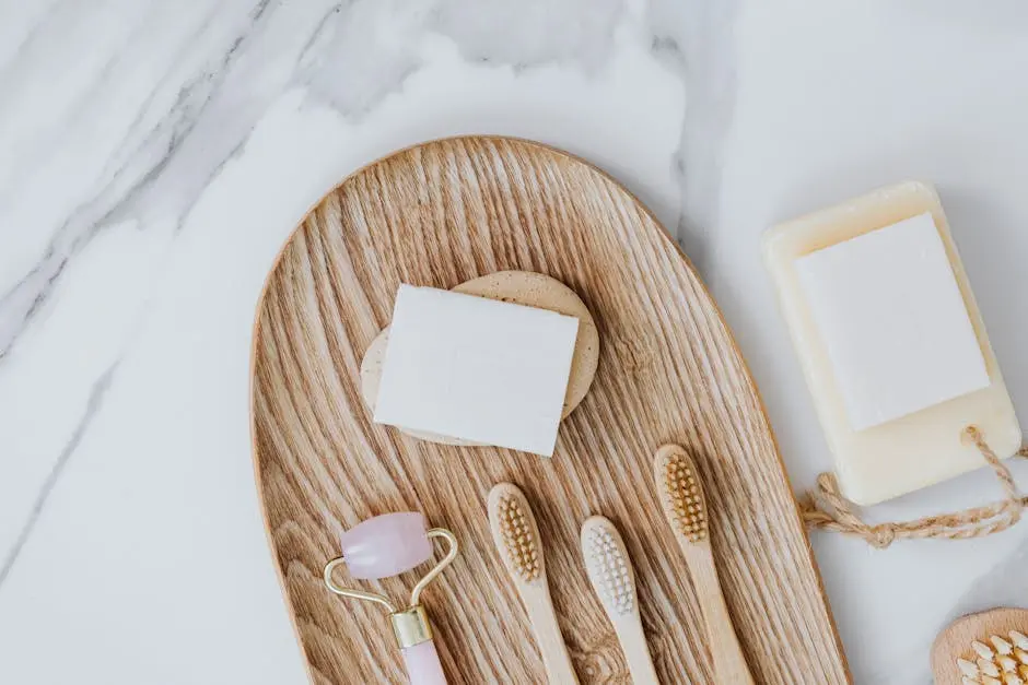 Flat lay of eco-friendly bathroom essentials including bamboo toothbrushes and natural soap.