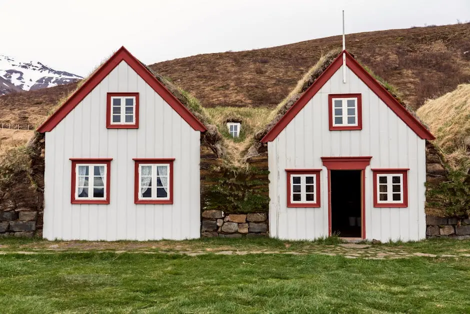 Scenic view of historic turf houses nestled in Iceland’s natural landscape.