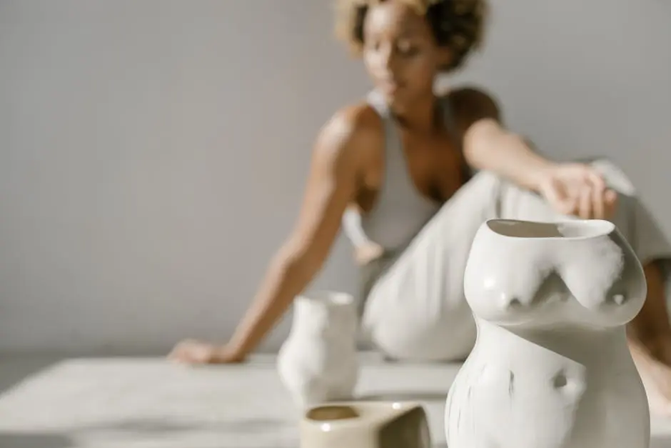 Artistic ceramic vases with human body shapes on a soft focused background.