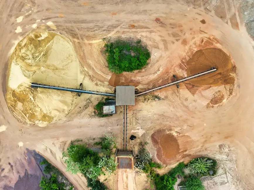 Aerial shot of a mining site featuring conveyor belts and sand piles.