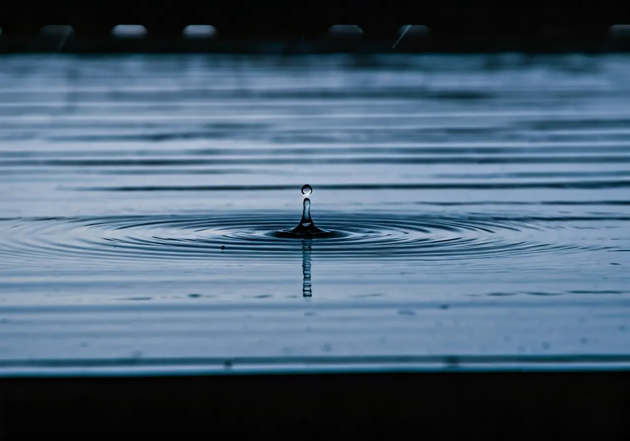 A raindrop rippling on a rooftop during a storm. 35mm stock photo