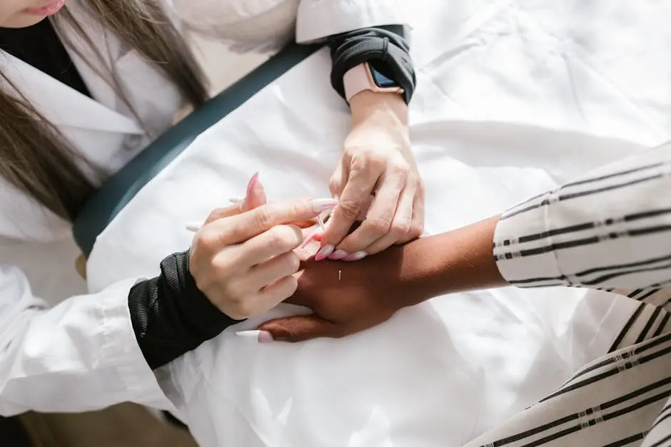 Close-up of a professional performing acupuncture therapy on a client’s hand for wellness.