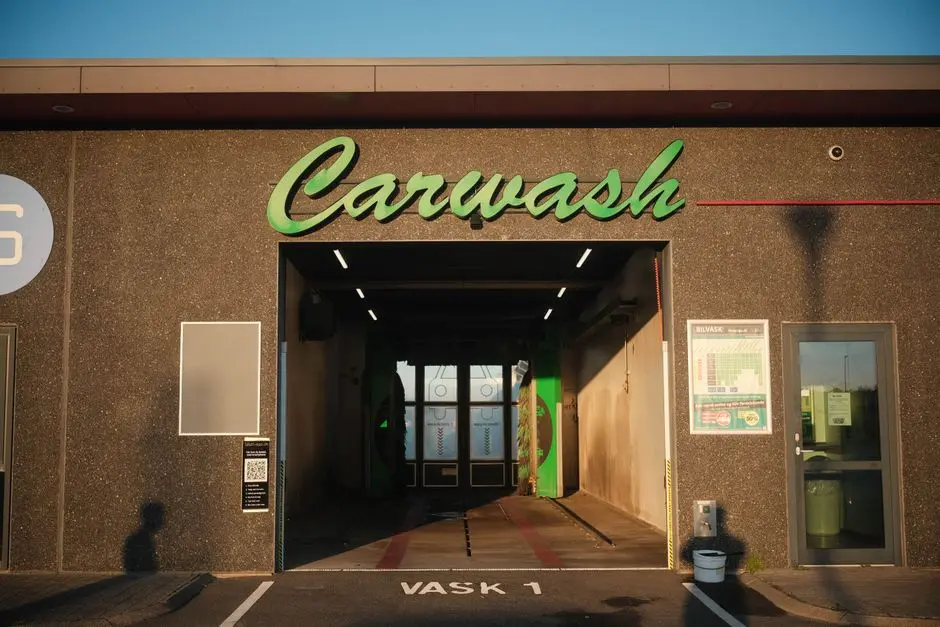 Exterior view of a carwash in Norway, featuring modern design and ambient sunset lighting.