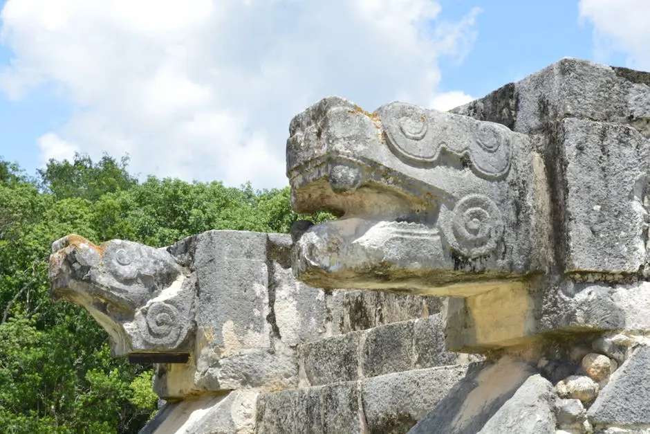 Close-up of ancient stone serpent sculptures at Chichén Itzá, capturing intricate Mayan craftsmanship.