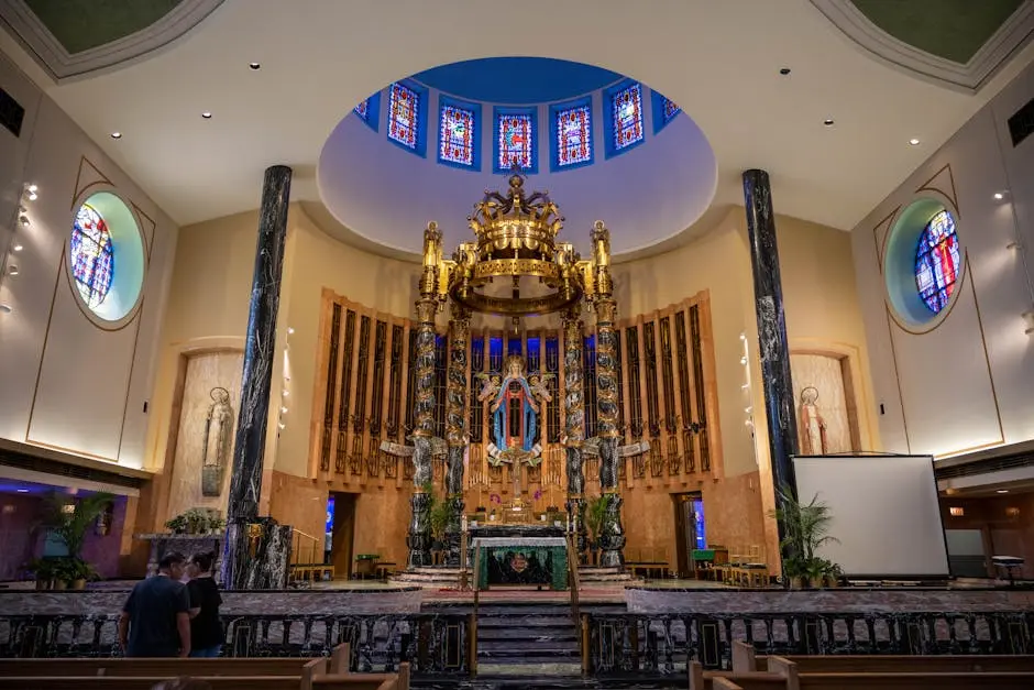 Stunning ornate church interior in Chicago featuring a grand altar and vibrant stained glass windows.