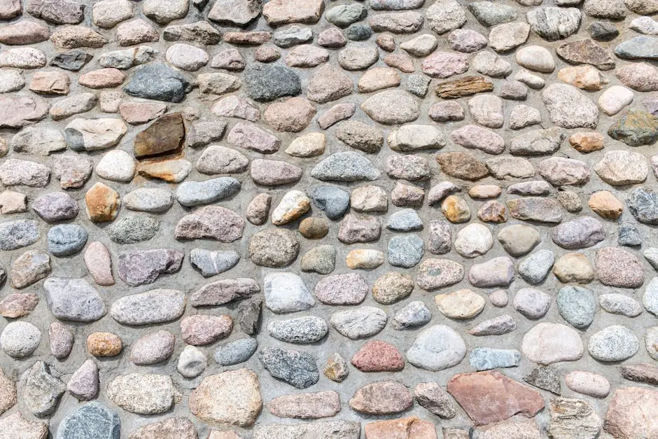 Close-up view of a textured stone wall in Hamburg with varied pebble shapes and colors.