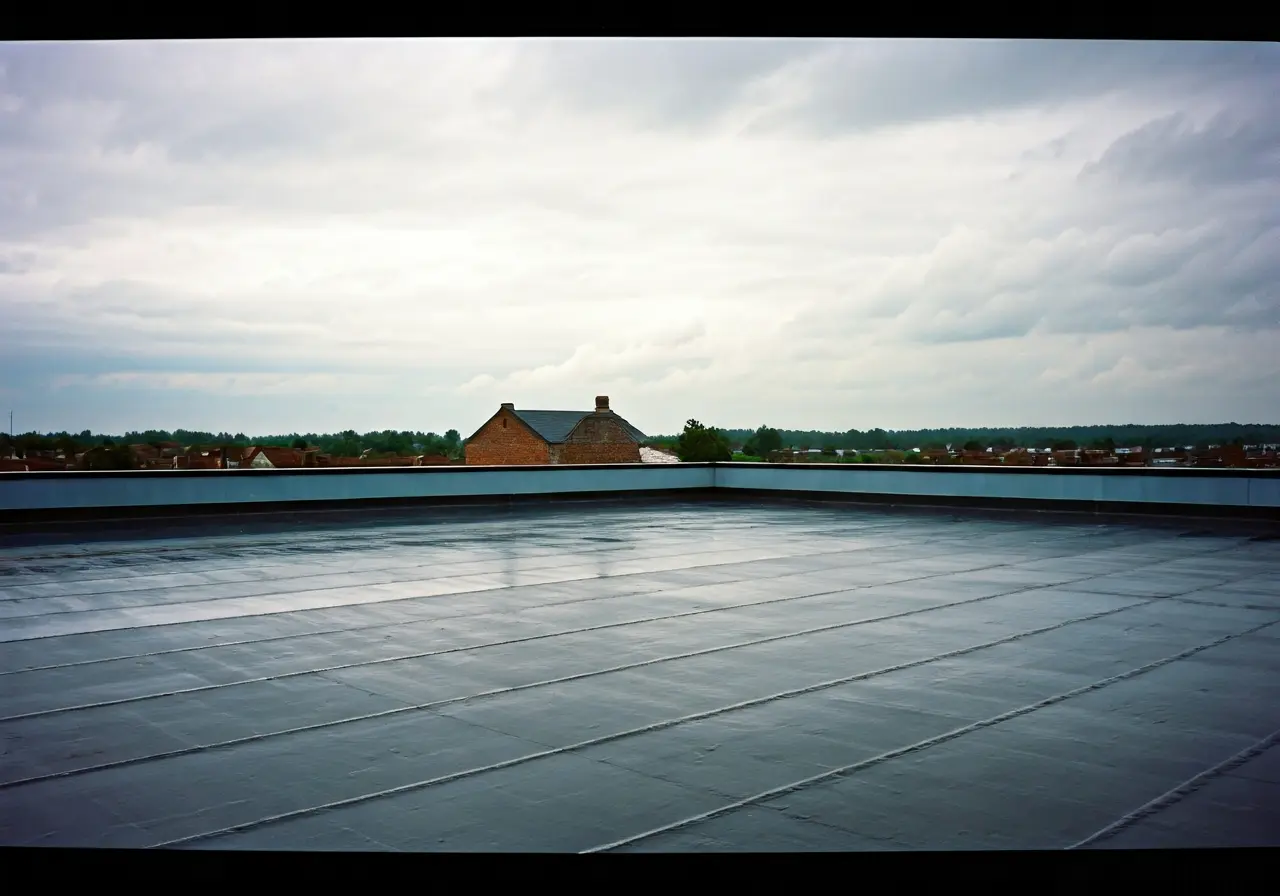 A flat rooftop with torch down roofing under rainy sky. 35mm stock photo