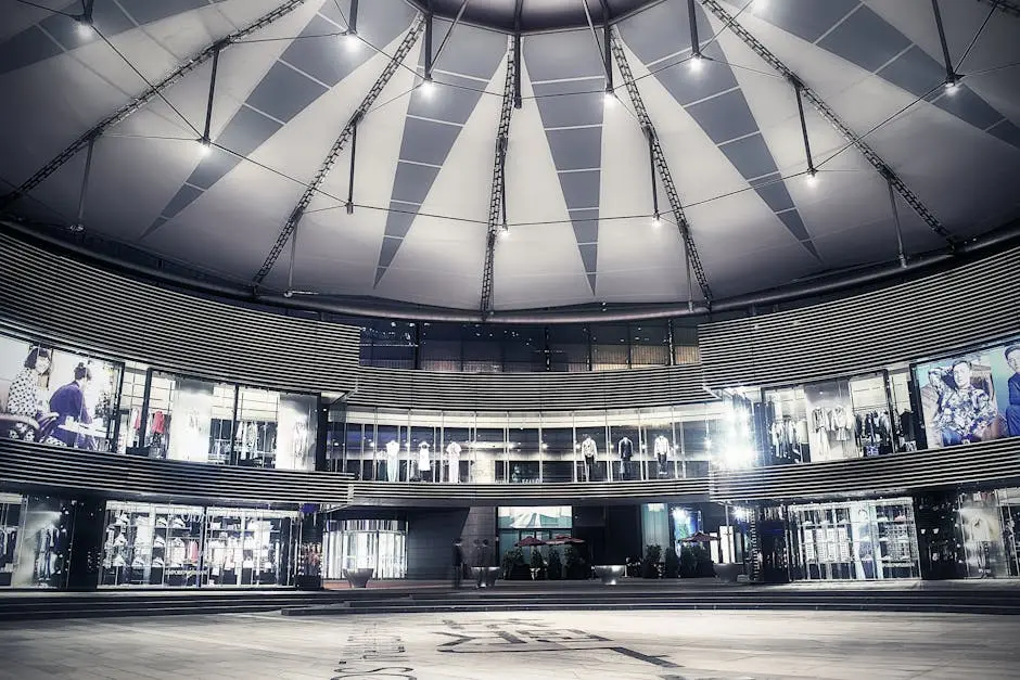 Explore the sleek, modern architecture of a Beijing shopping mall with glass facades and a geometric ceiling.