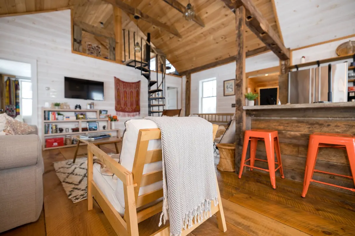 Cozy interior with rustic and modern design elements, featuring wooden beams and bright decor.