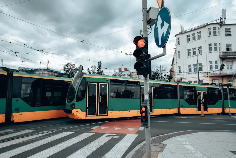 Green and yellow trams at a city intersection in Poznań, capturing urban transportation.