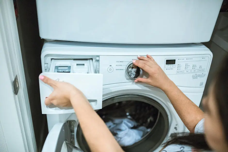 A person in a laundry room adjusting settings on a washing machine.