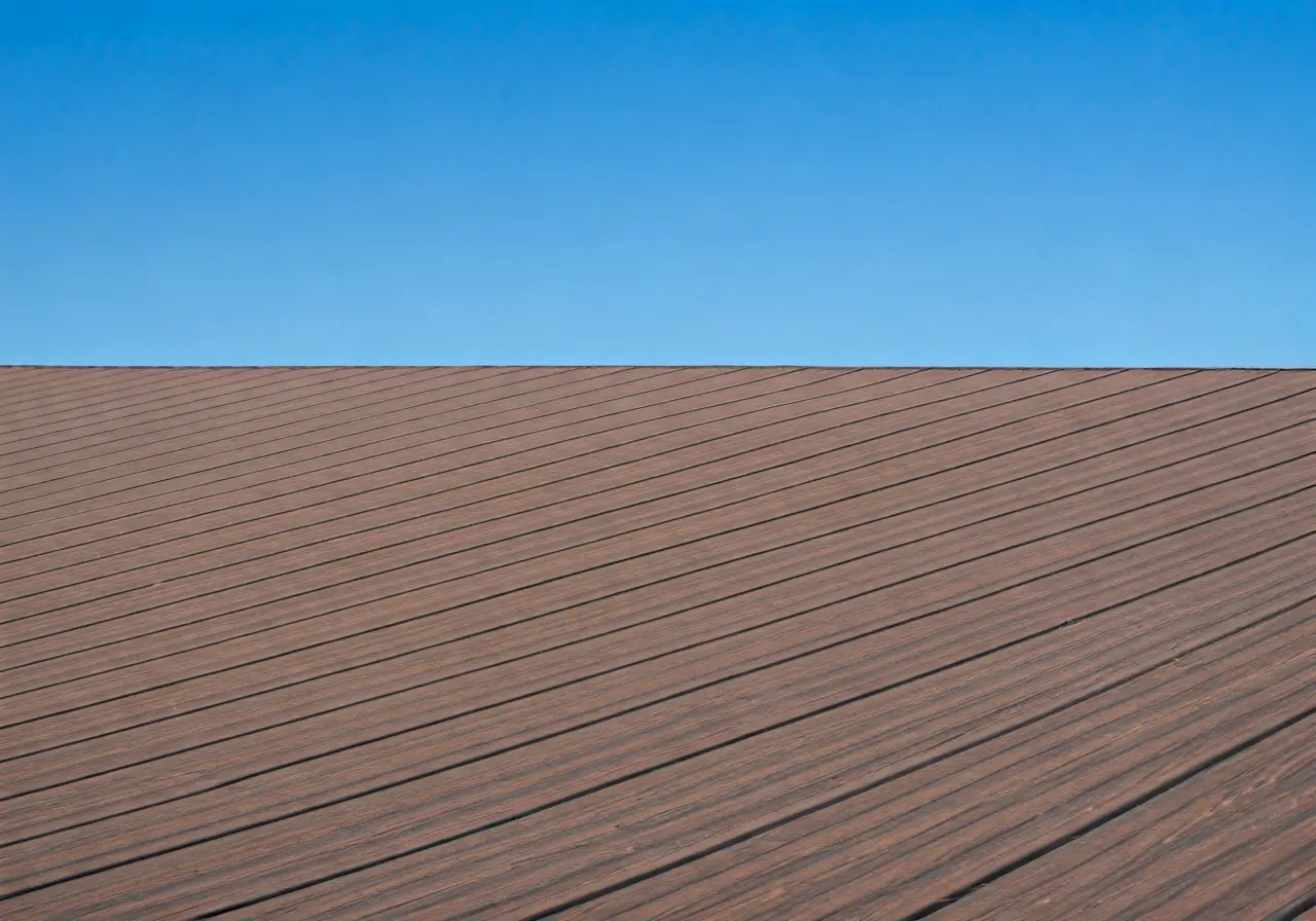 A well-maintained composite roof under a clear blue sky. 35mm stock photo