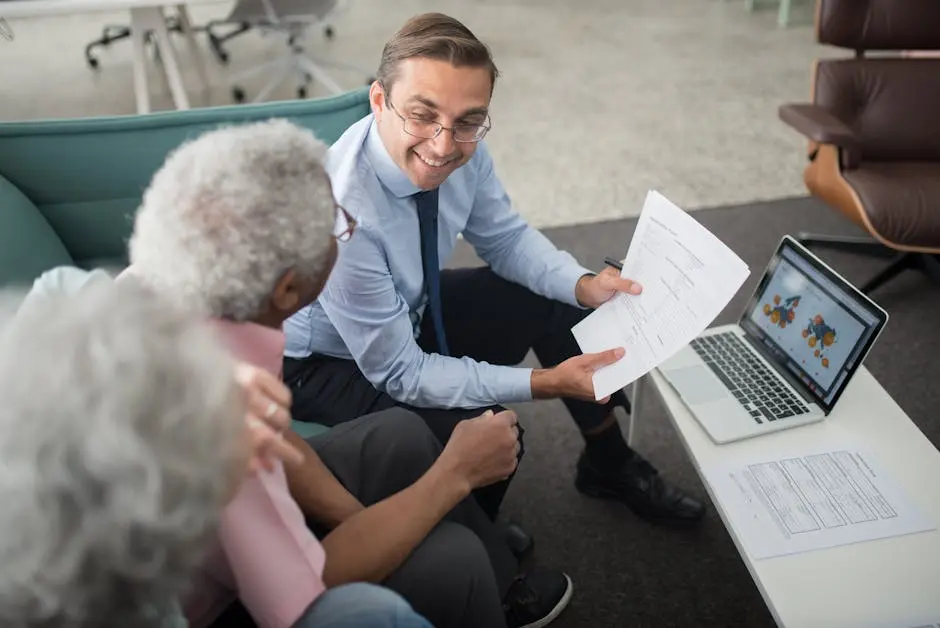 Financial advisor discussing documents with senior clients in an office setting, showcasing a collaborative consulting session. small business consulting | ej bowen